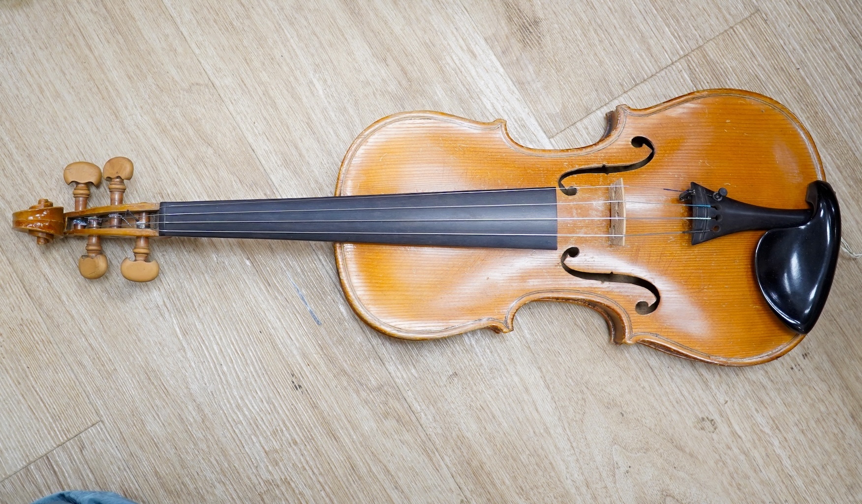 Two cased three quarter size violins, one labelled the London violin Co Ltd, length of back 33.5cm. Condition - both scratched